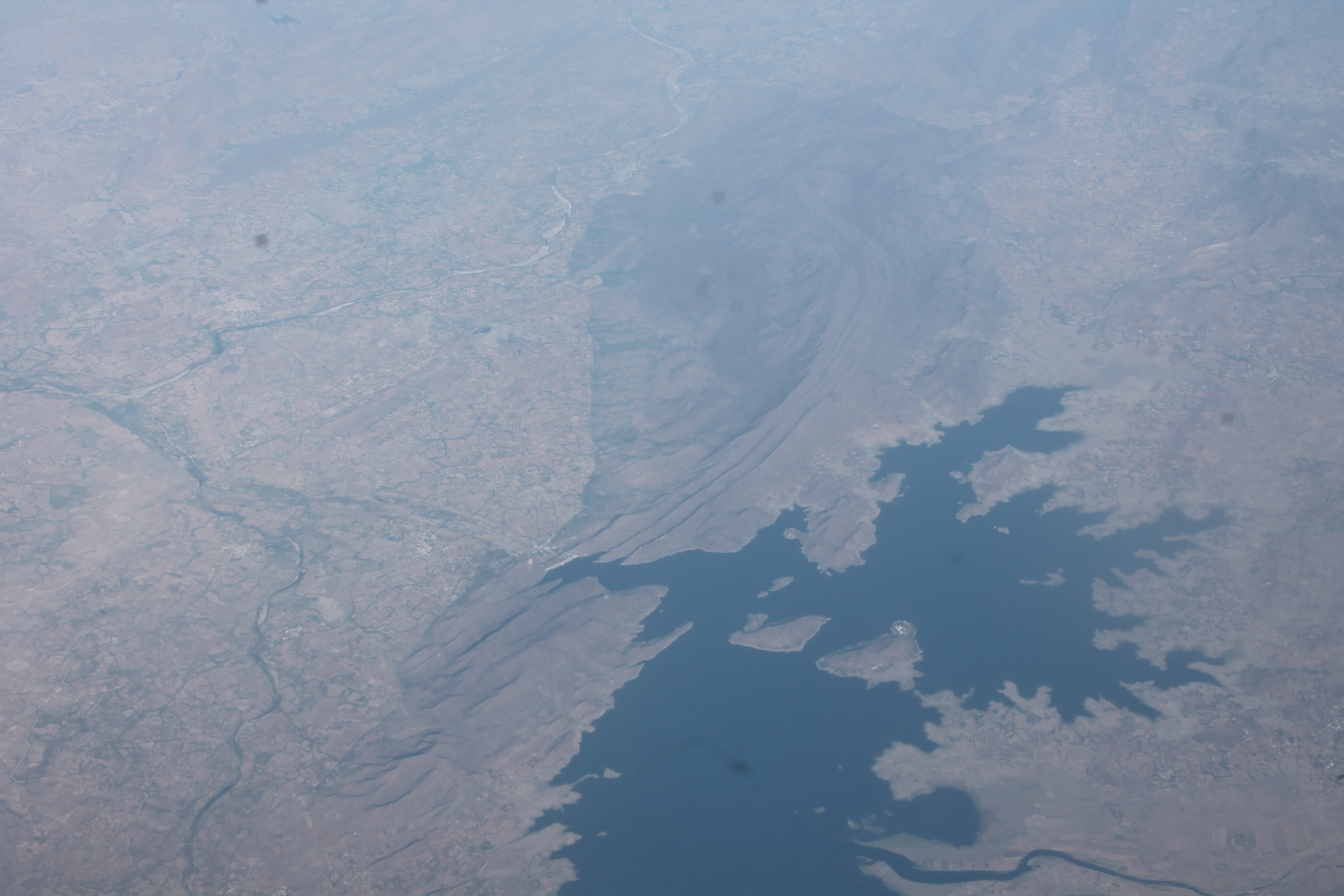 The view of a lake created by a dam in India as seen from a plane on the way to Delhi
