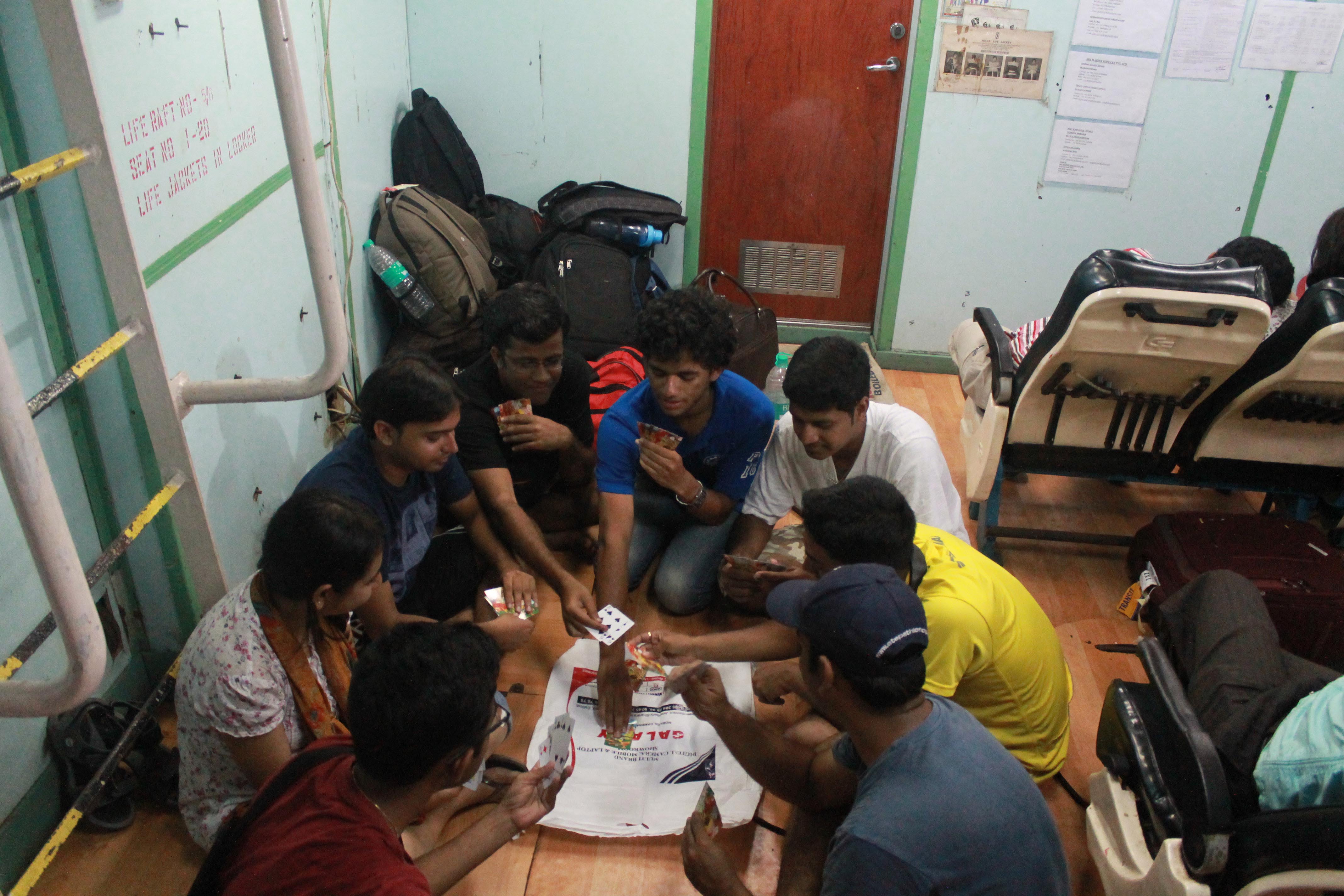playing a game of cards on the floor of the boat