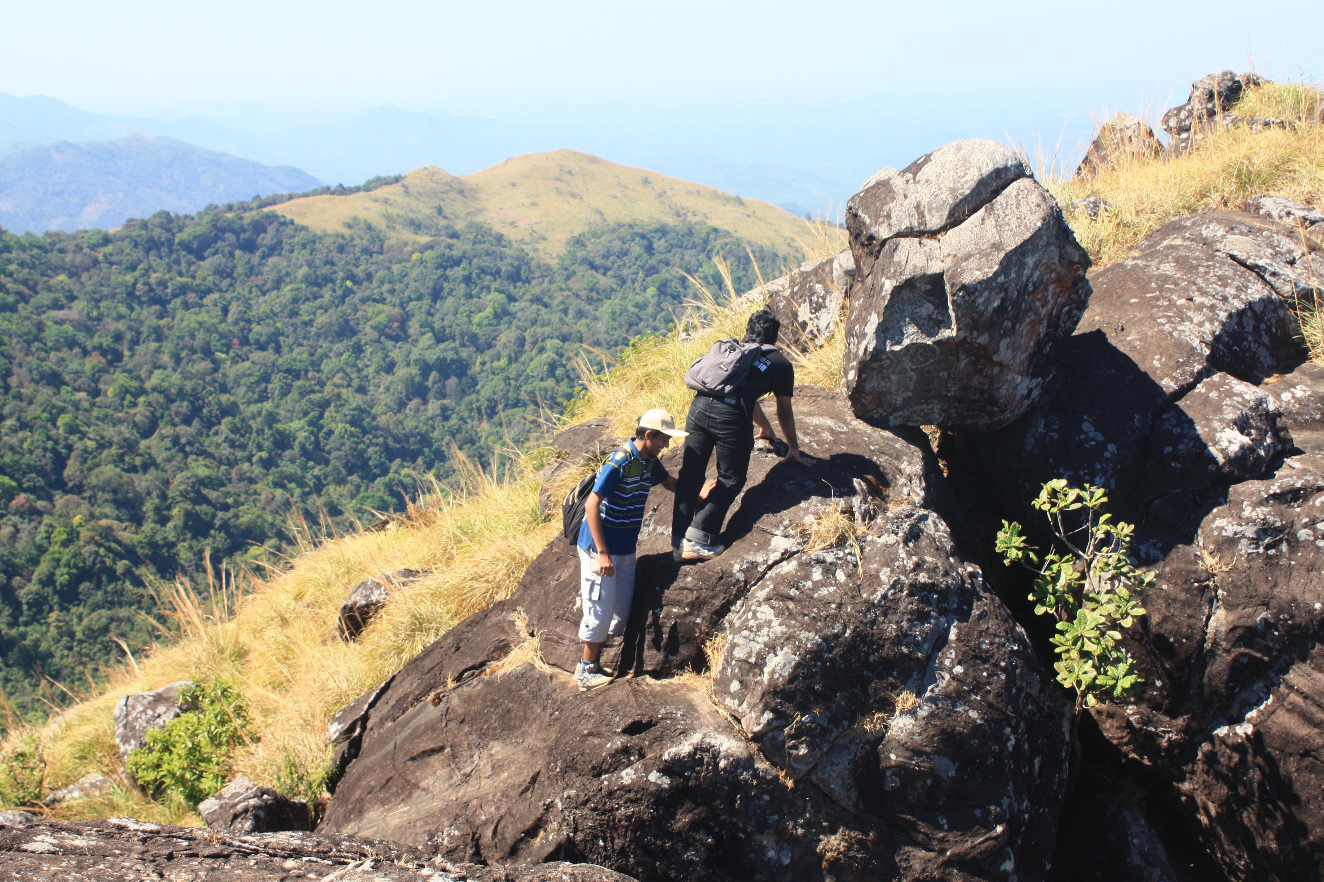 Climbing up near boulders in Ranipuram during the trek