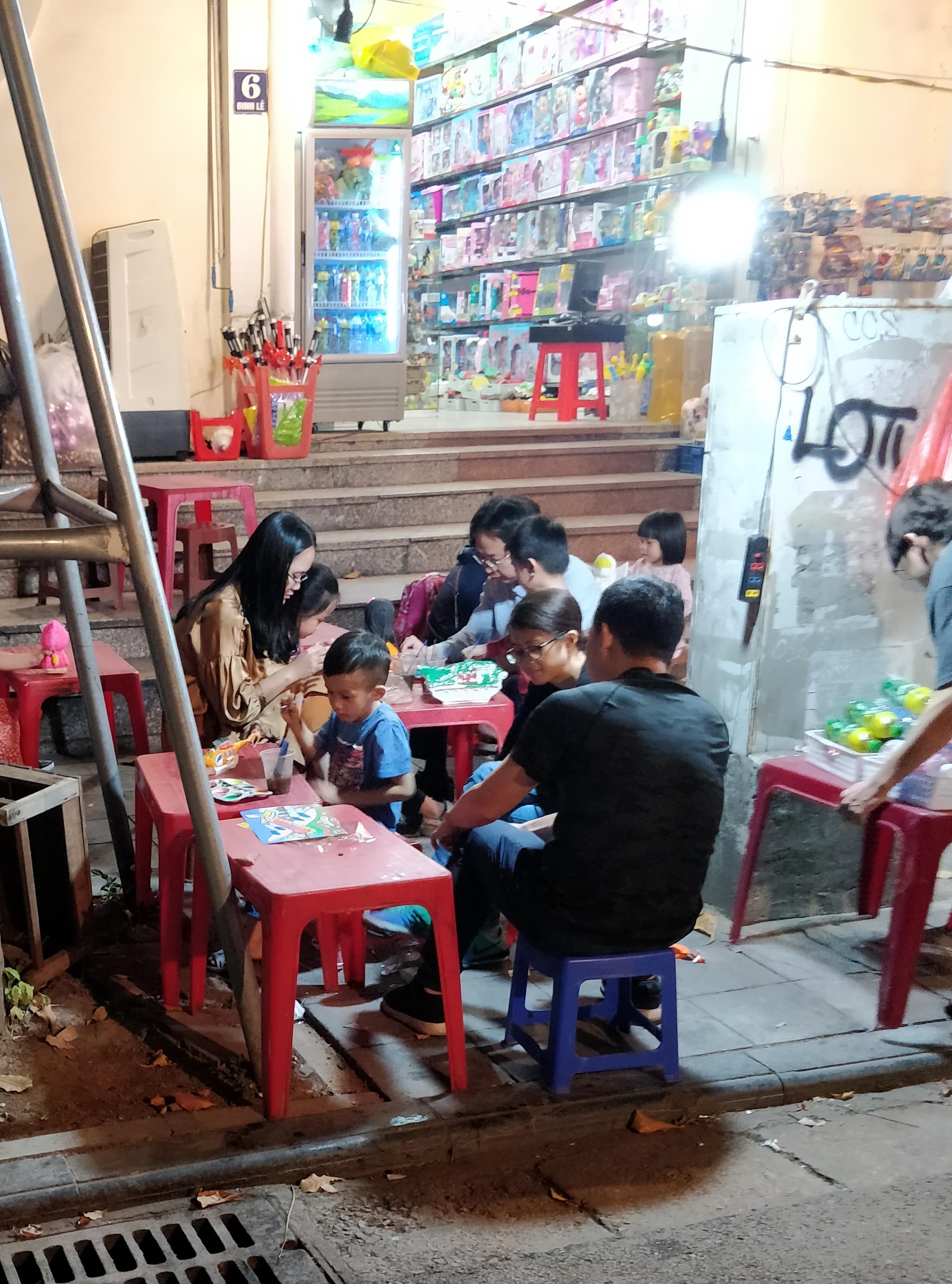 Kids painting on the sidewalk in Hanoi