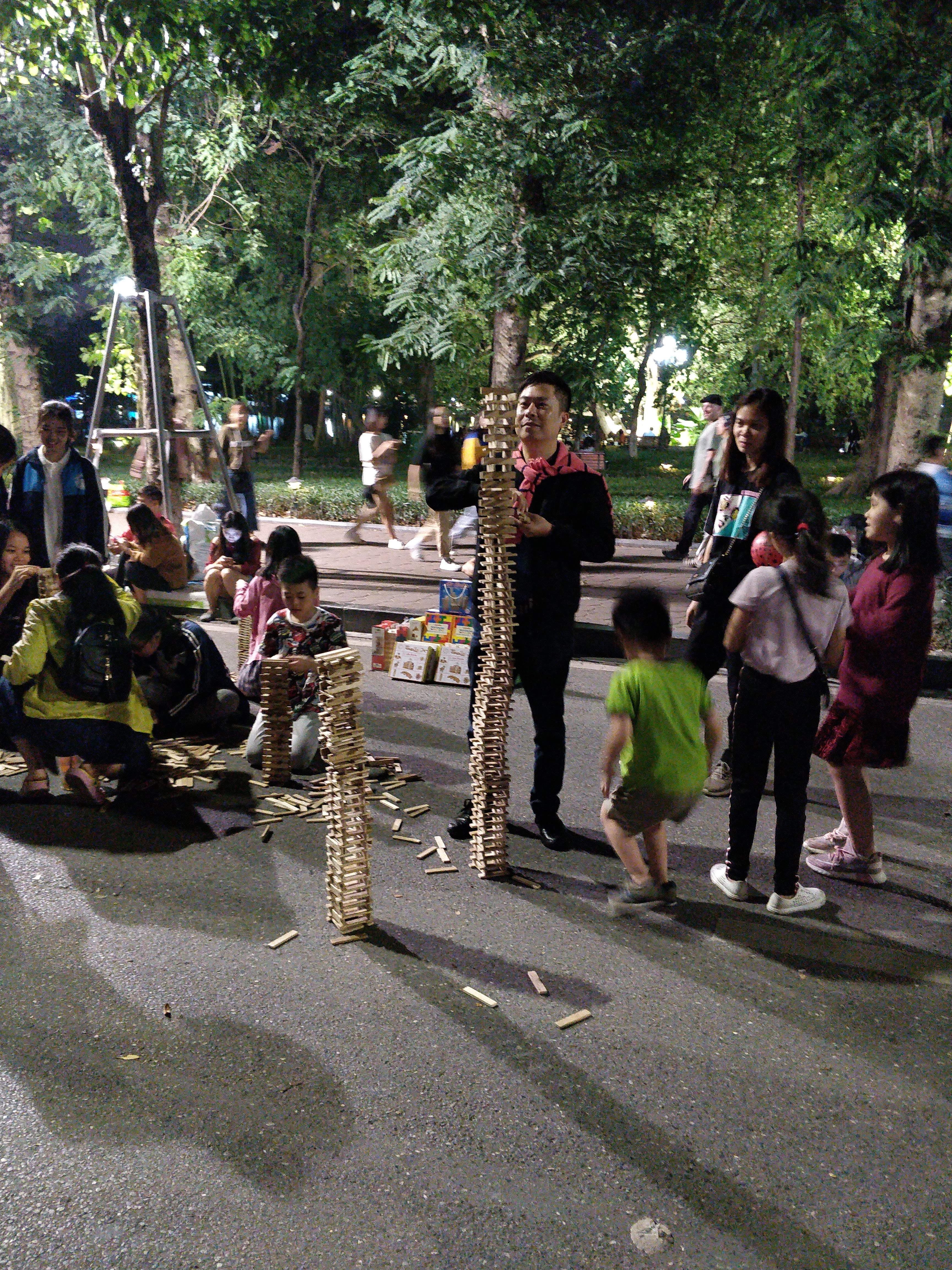 People playing games in the middle of the road - this road was jam packed with vehicles just a few hours before!