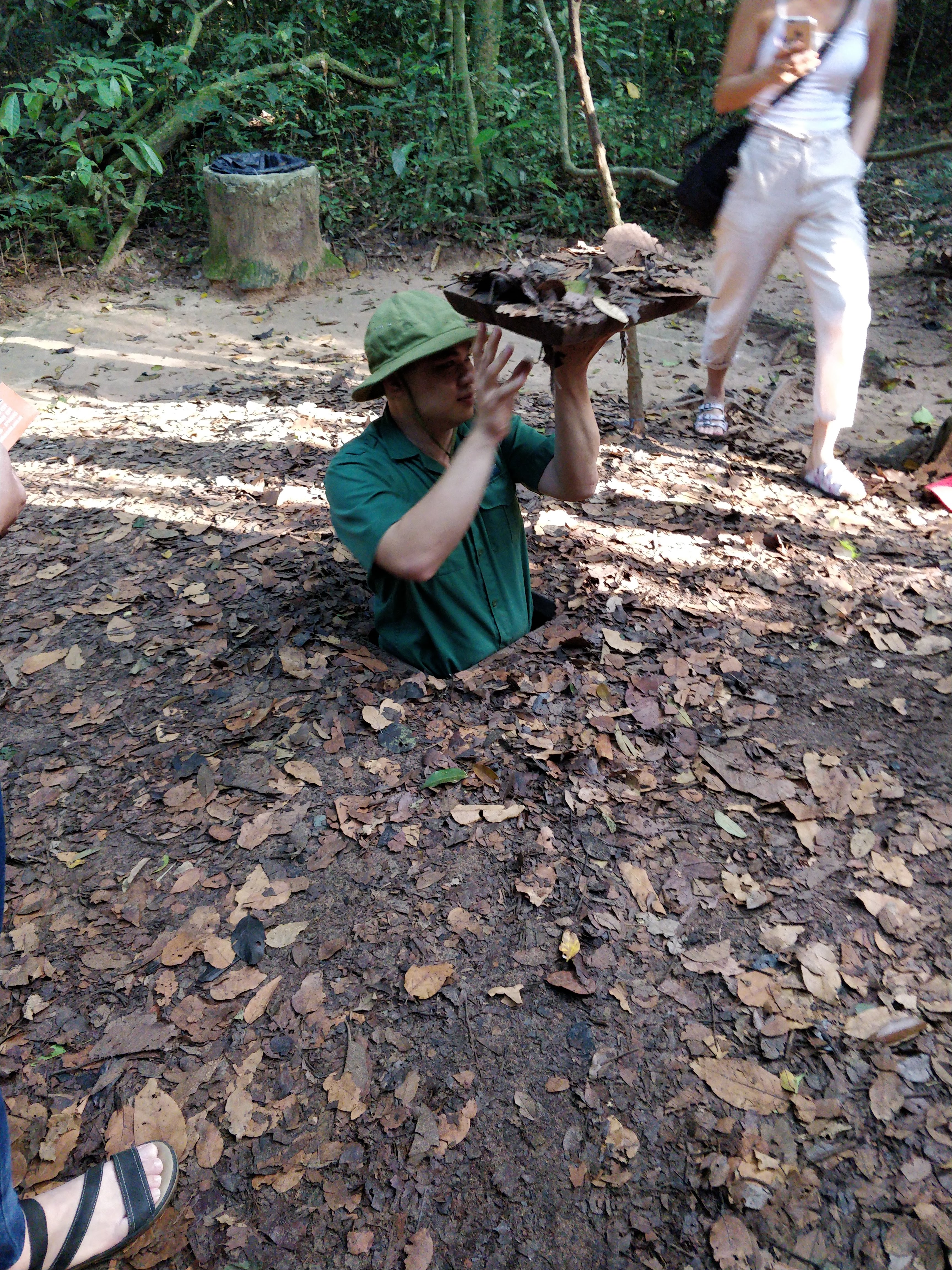 The entrances to the tunnels are quite narrow and concealed under the mud and leaves in Cu Chi tunnels Vietnam