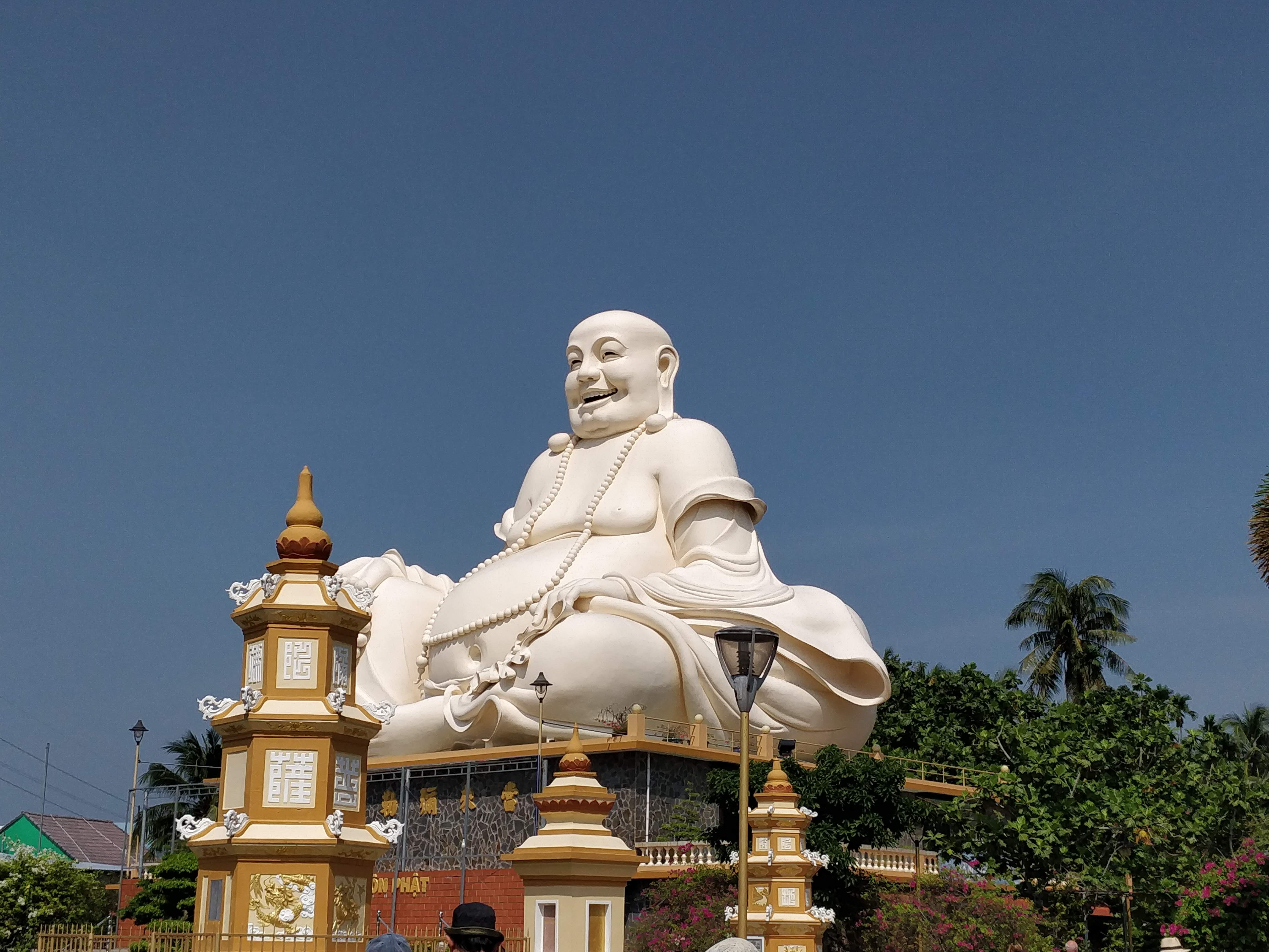 The laughing Buddha at Vinh Trang Pagoda of Mekong Delta