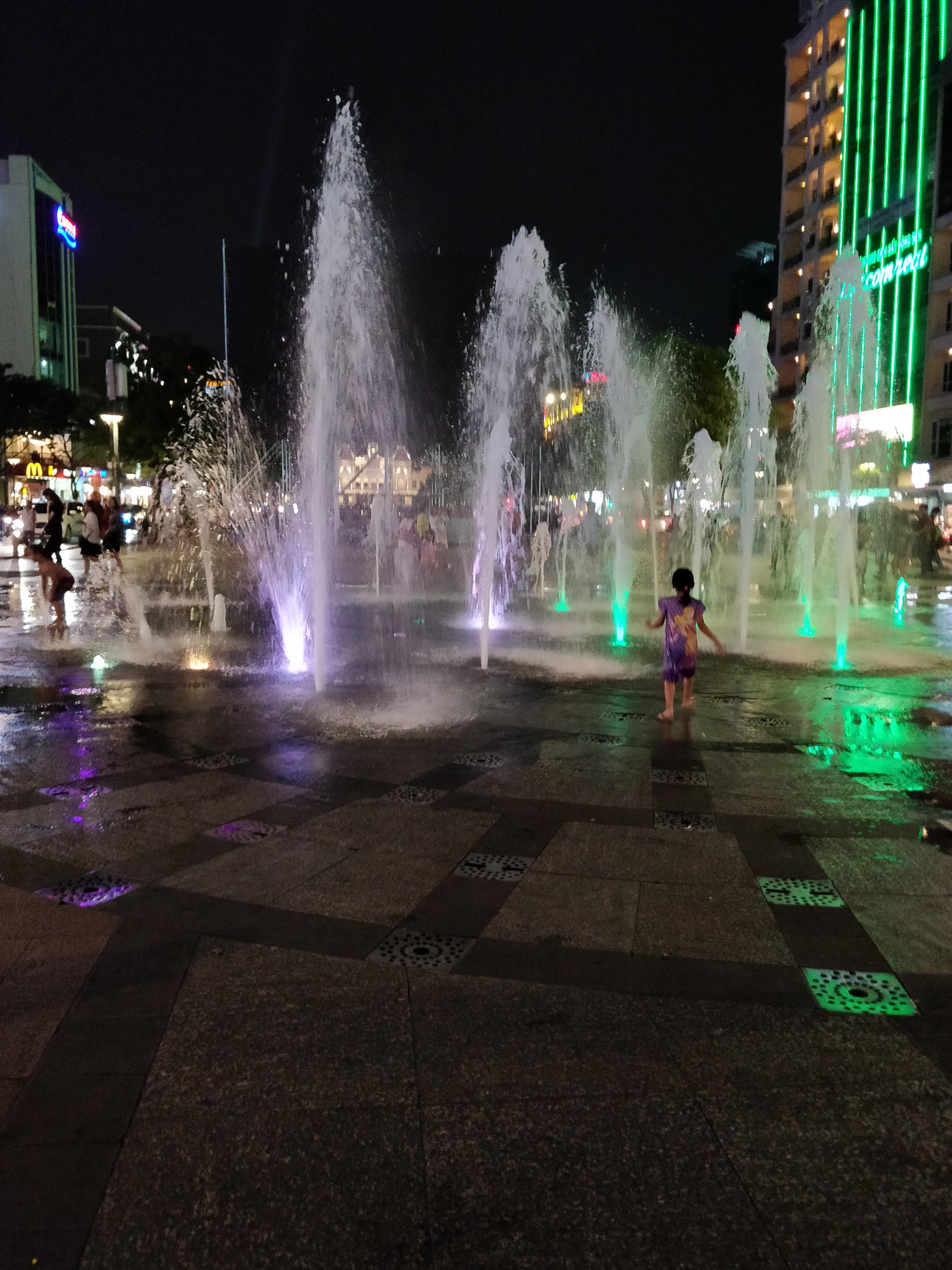 Kids playing in the water fountains in Ho Chi Minh City
