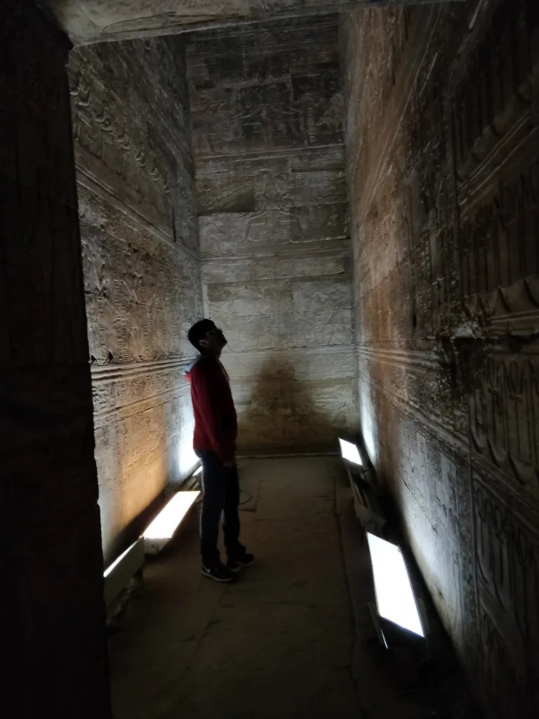 Standing inside an Egyptian temple covered by hieroglyphs