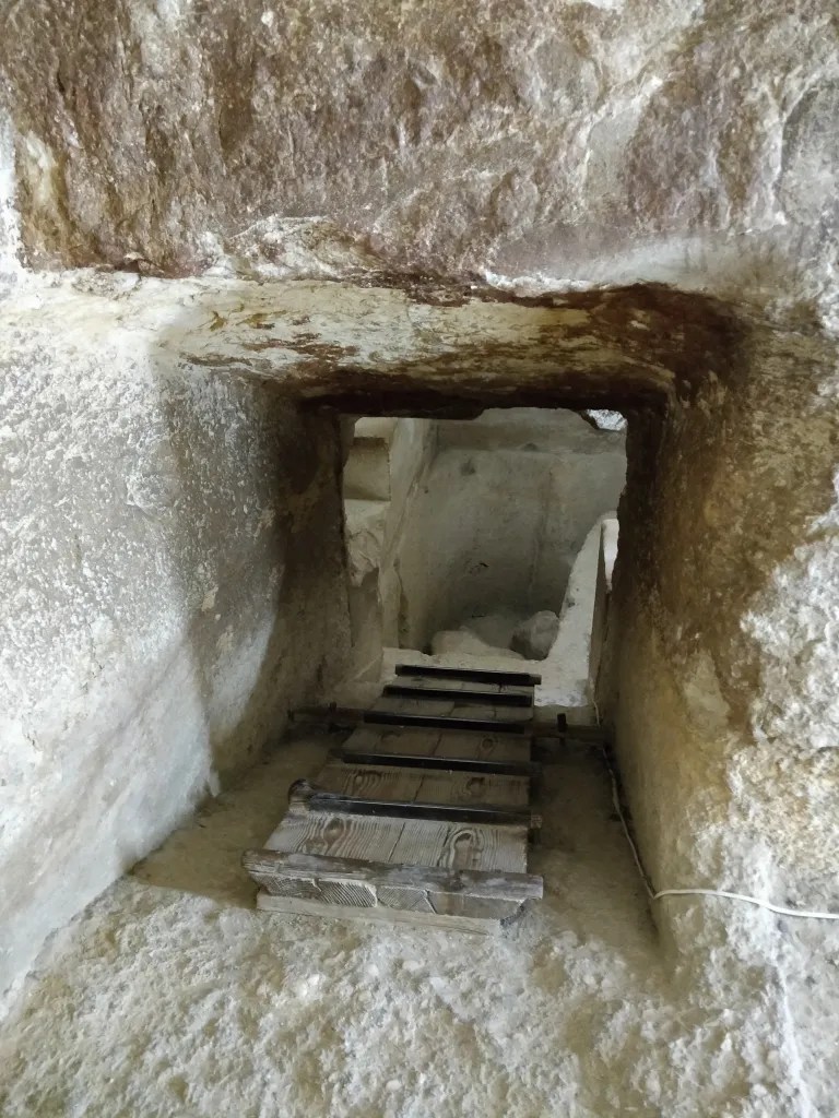 wooden steps leading down into the pyramid in Giza