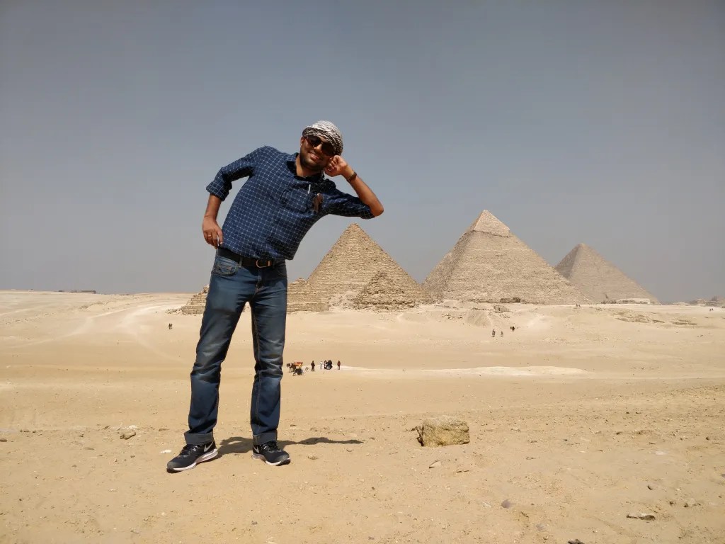 Posing in front of the pyramids