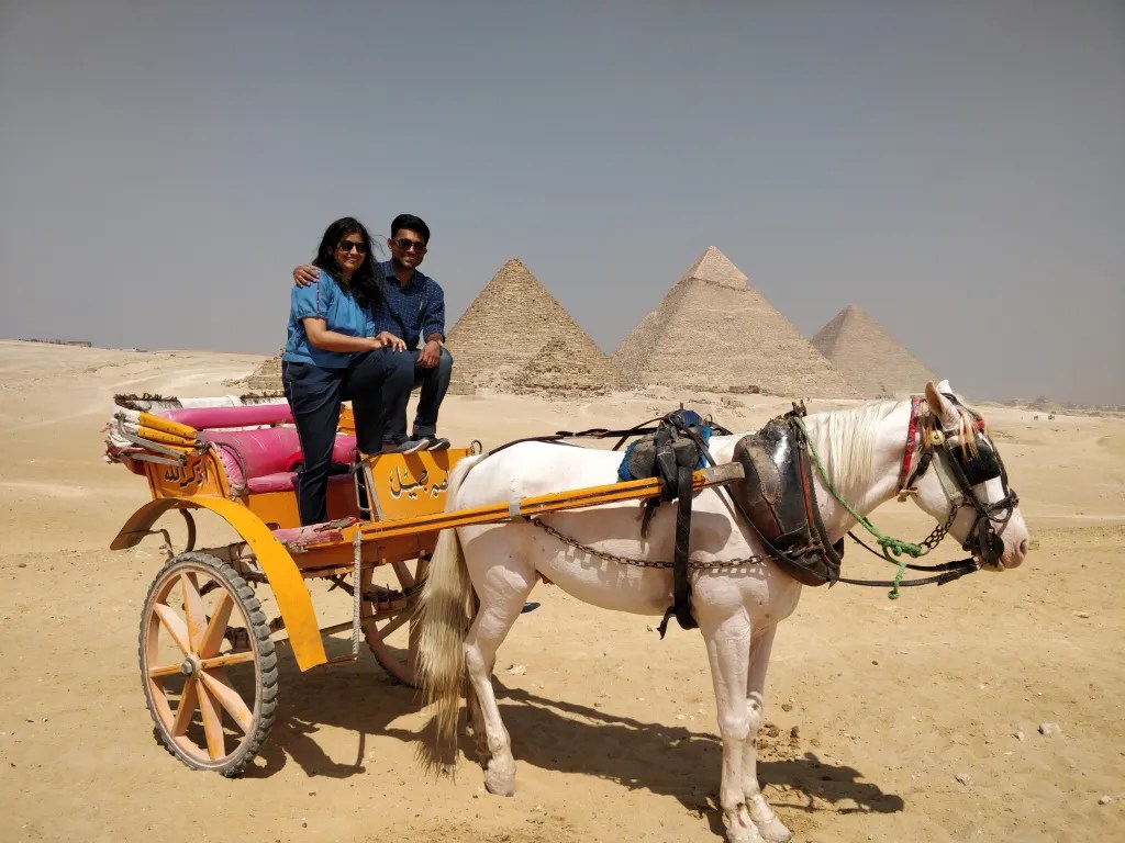 Posing in front of the pyramids with the horse carriage