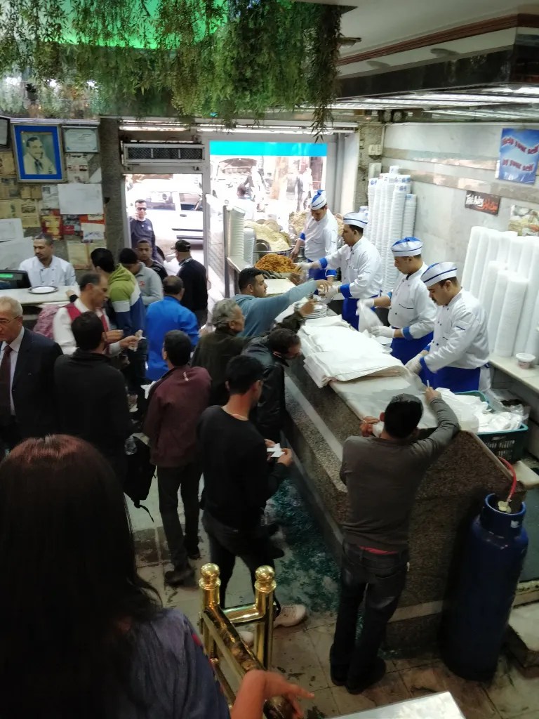 Workers quickly assembling koshary at Abou Tarek Koshary in Cairo