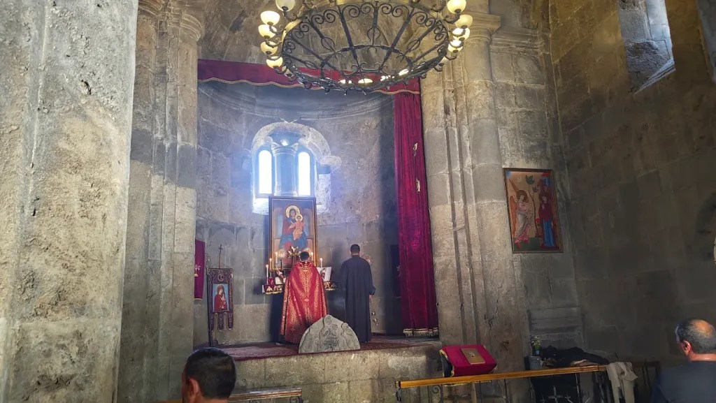 A priest offering prayers inside the Haghartsin monastery